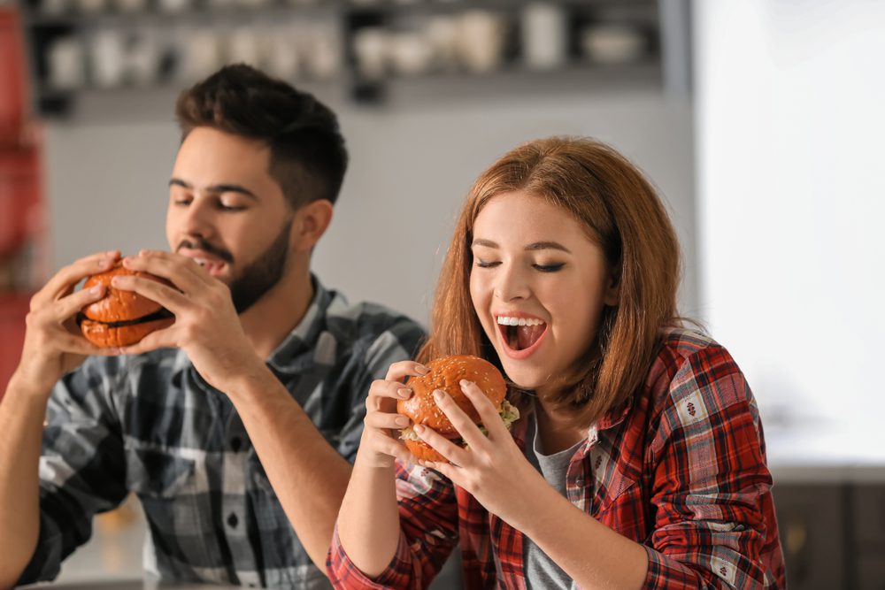 couple eating burgers